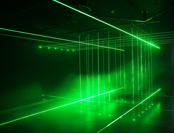 Li Hui says about his work 'Cage': "There are two cages inside the work made of laser beams. Laser beams are special in a way that they look tangible while in reality they are not. The two cages appear alternatively so that a group of people who find themselves 'trapped' in the cage in one moment would suddenly find themselves outside the cage in the next. This work brings out the contrast between reality and illusion." 'Cage' (each 200 x 200 cm; height variable) is made of laser lights, mirrors and iron. Image courtesy of Ministry of Art.